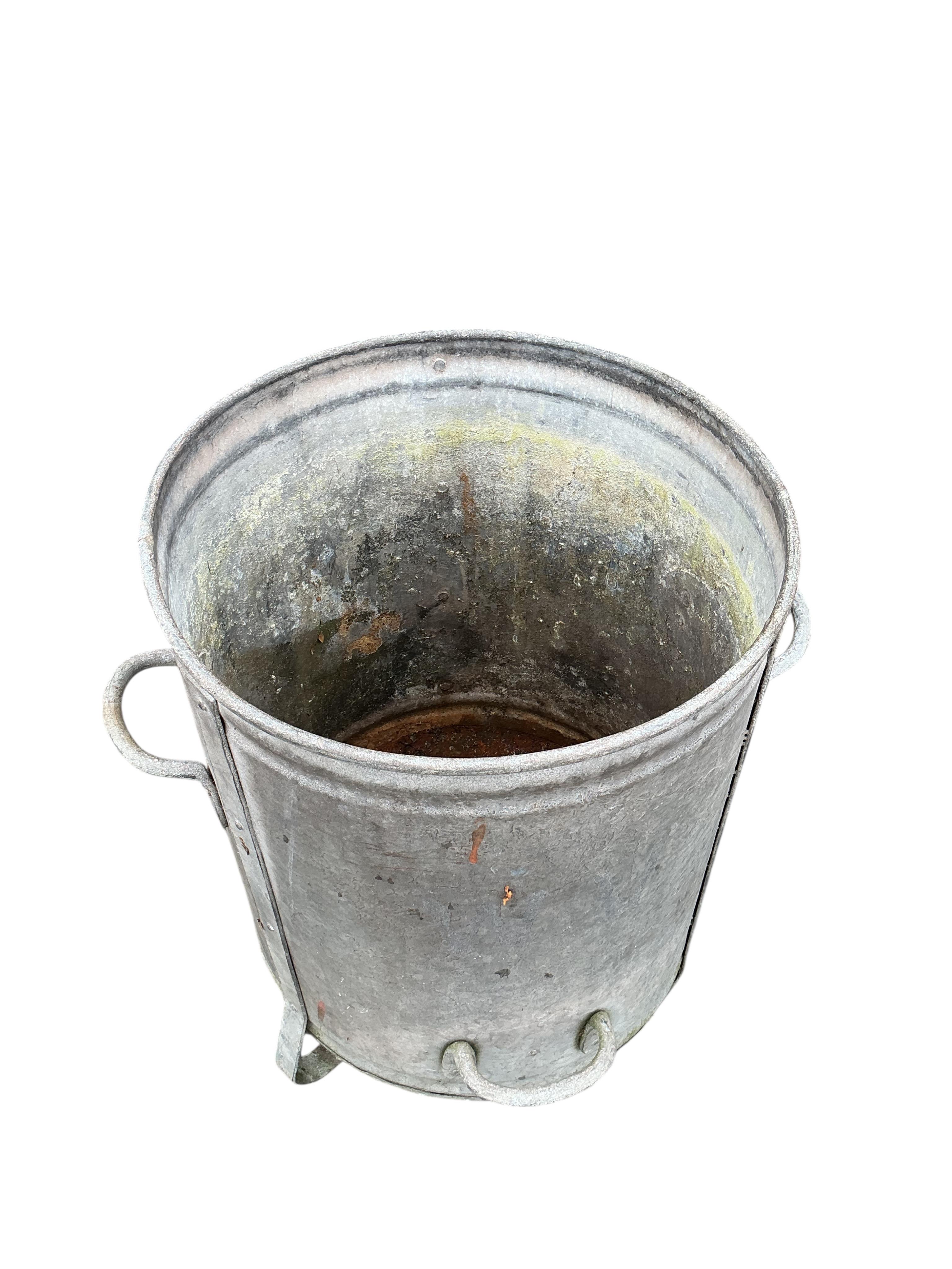 Two galvanised metal barrels, larger diameter 47cm, height 62cm